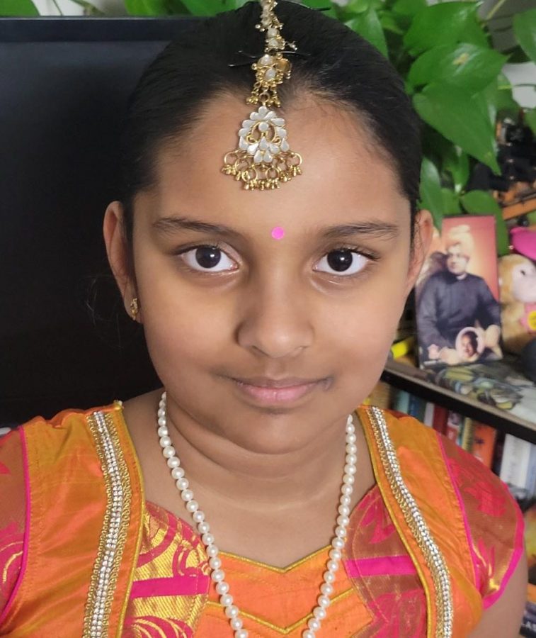 Wearing a traditional Indian dress is a fourth grader Jayani. The KumKum between her eyebrows is a powder used for social and religious markings in India. It is usually made of tumeric.