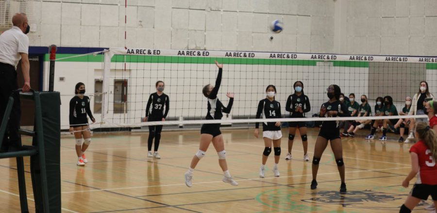 Clague 7th and 8th grade girls volleyball team hitting the ball across the net during the match against Forsythe.
