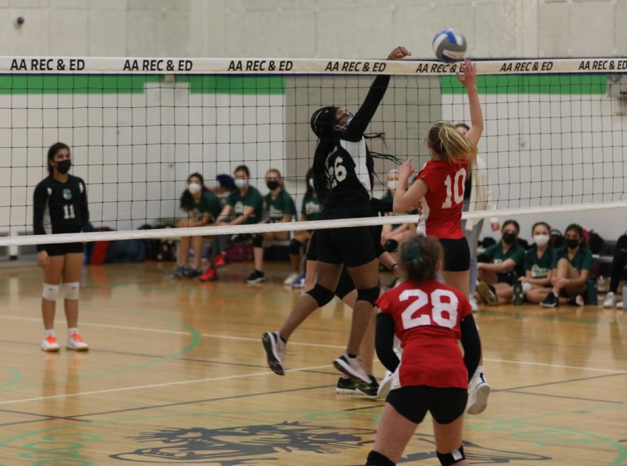 Clague 7th and 8th grade girls volleyball team blocking an offensive play during the match against Forsythe.