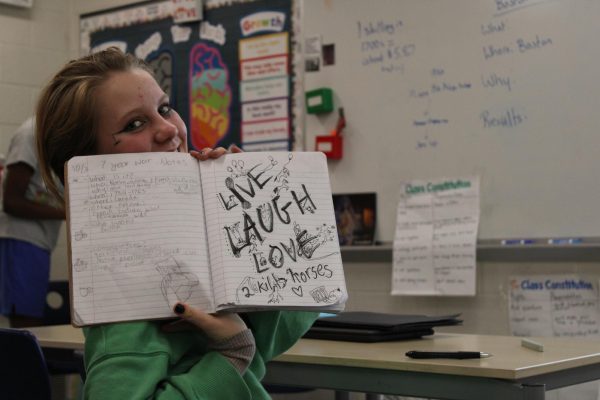 8th grader Lexi Wurster-Dillard smiles for the camera at Clague Middle school.