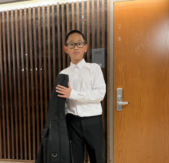 Andre is a sixth grader at Clague Middle School. This picture shows him with his cello.
