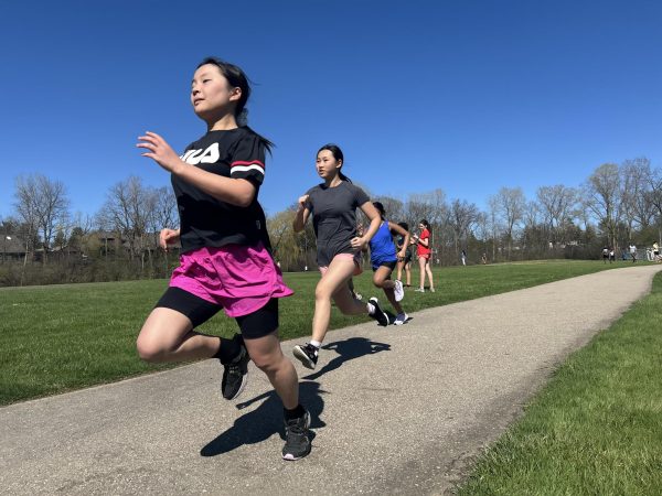 Eighth graders Haruka Inada and Amy Yang sprint during track practice.