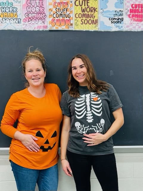 Clague teachers Meredith Pelchat and Abby Ruehlmann share their pregnancies through Halloween shirts.