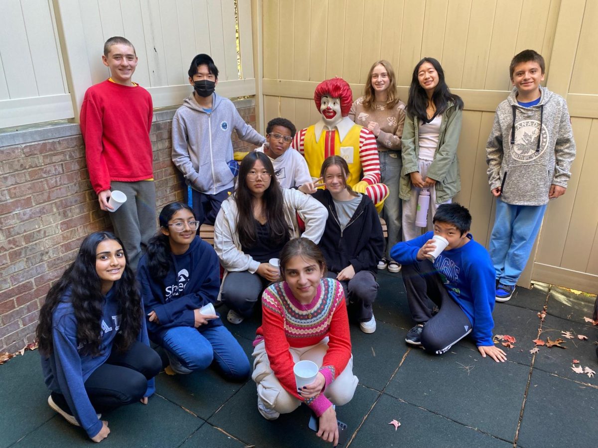 The Clague student council group gathered around the Ronald McDonald statue.