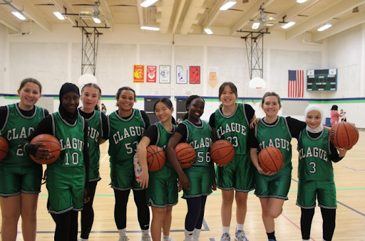  Seventh graders on the basketball team posing for a picture.