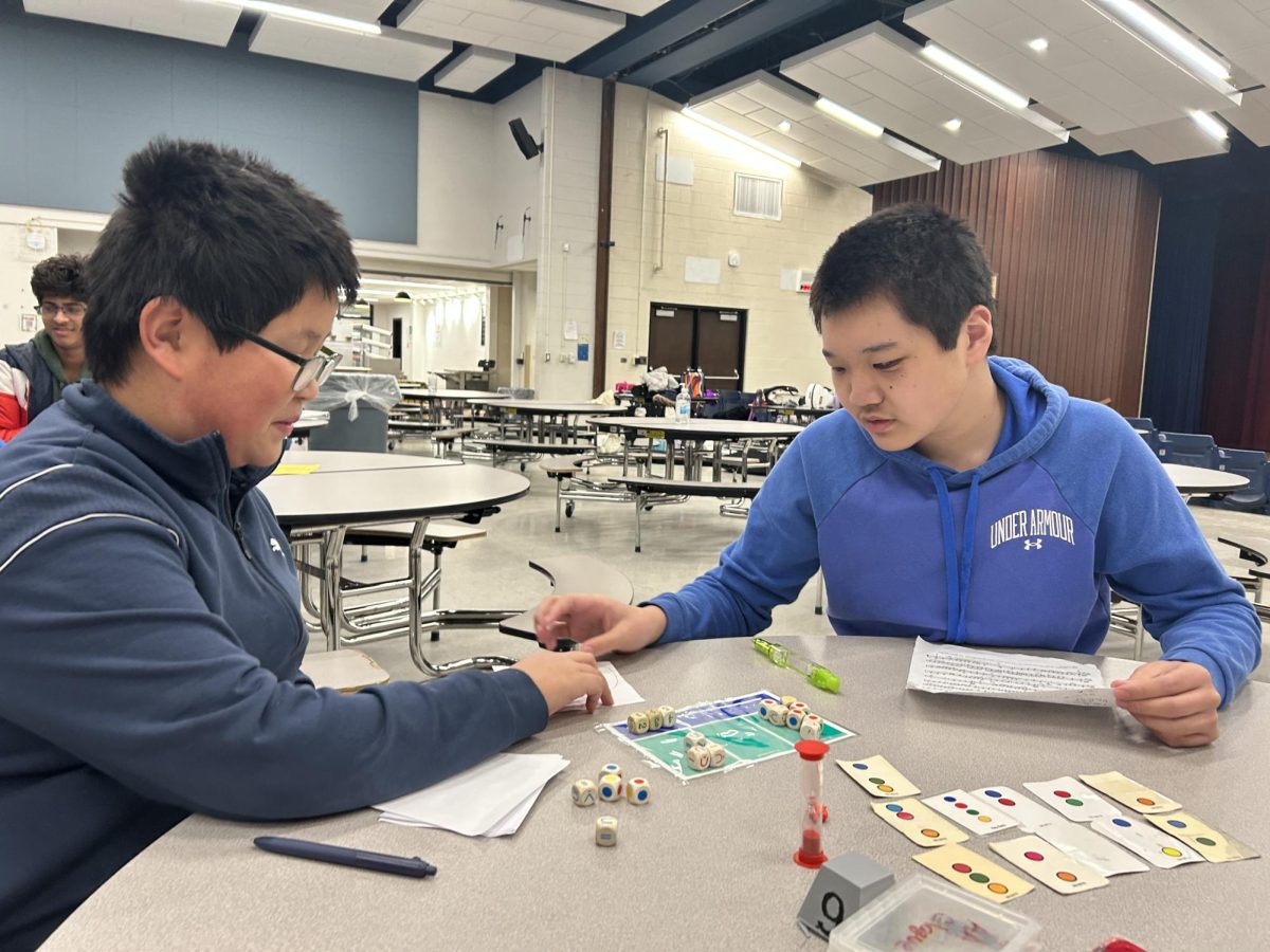 Clague eighth graders and members of Academic Games (AG) David Fry (left) and Jason Lu (right) doing an activity.