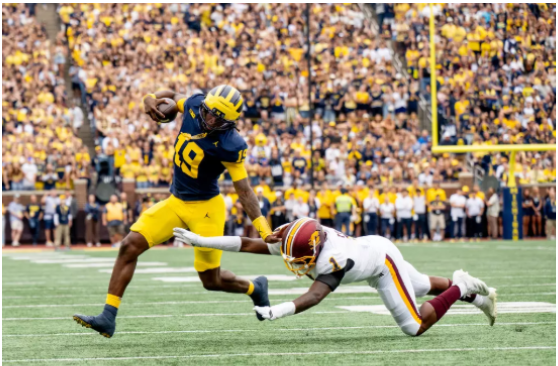 Michigan Quarterback Bryce Underwood stiff-arming a Central Michigan defender. Underwood rushed for 114 yards and two touchdowns in a very impressive performance. 
