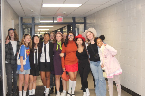 A group of eighth graders posing for a picture at the start of the Harvest Moon fun night. 