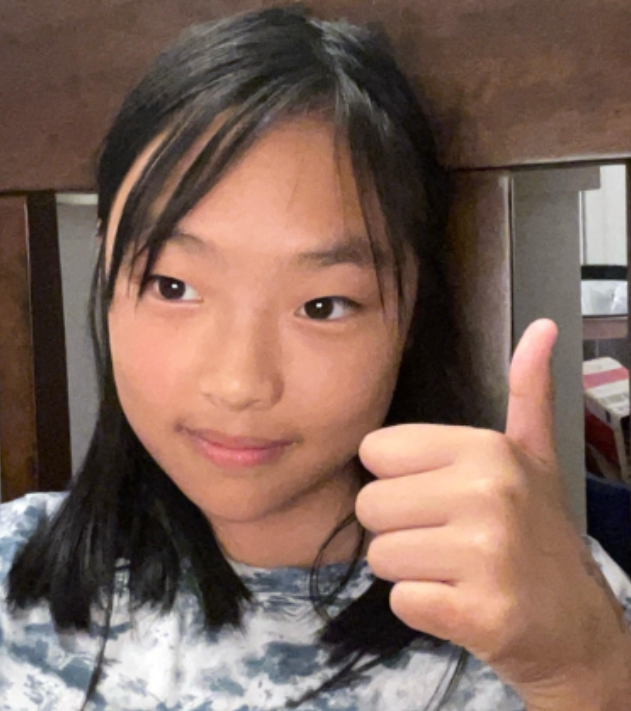 Elaine Wu giving a thumbs up for the camera.