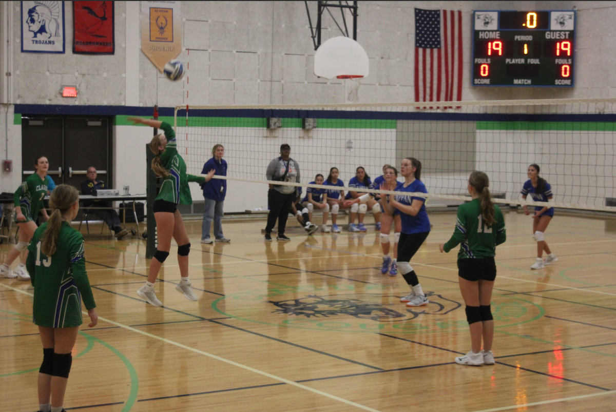 With the game tied, seventh grader Berlynn Shafer takes a swing at the ball, trying to win the point and get a kill.
