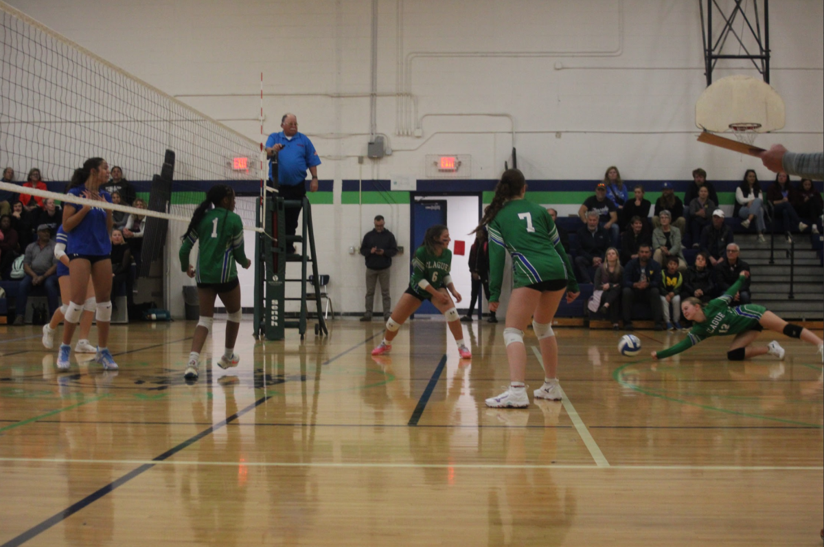 Before touching the gym floor, the volleyball team make an attempt gain a point through a dig.
