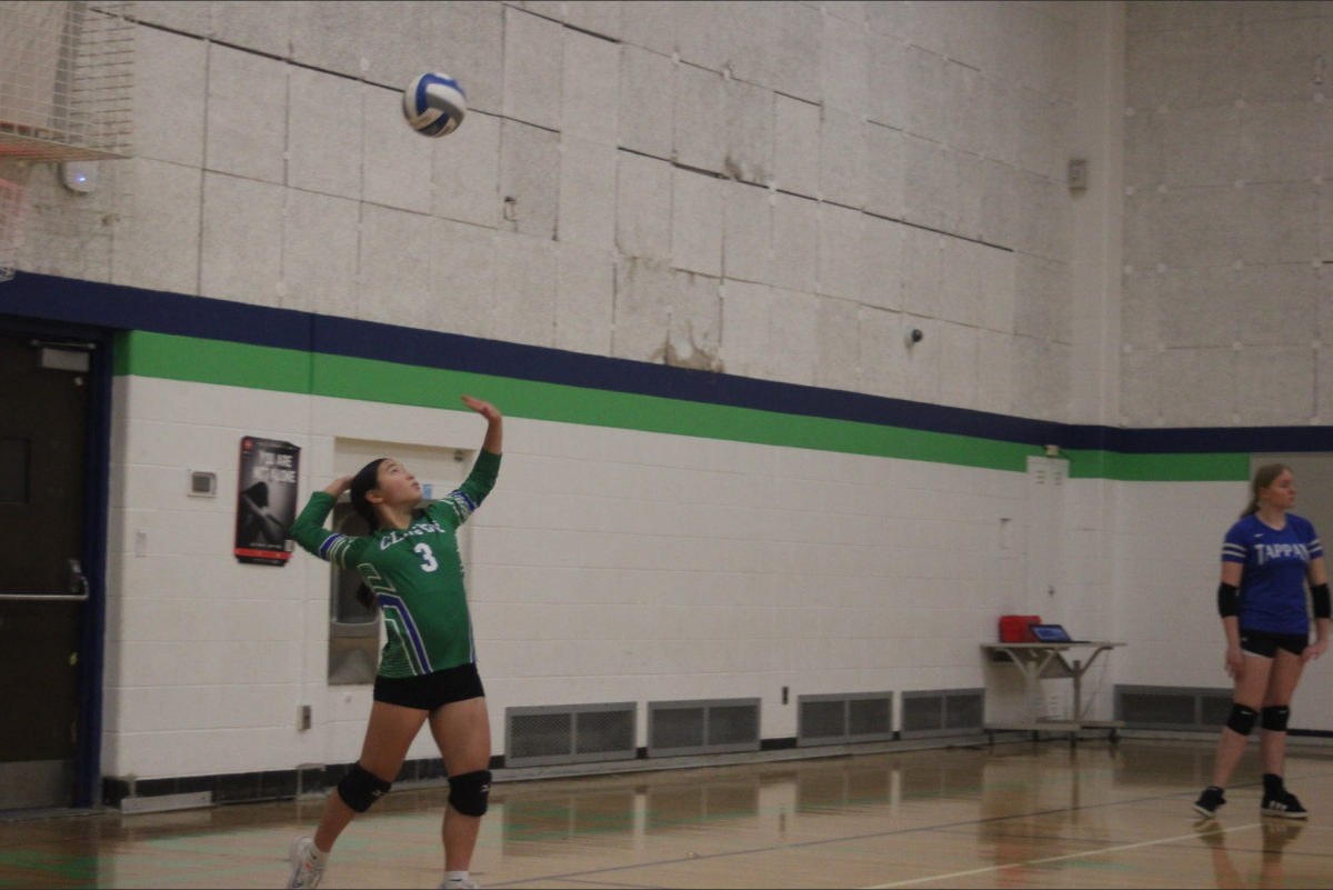 Eighth grader Sharon Lee reaches back to serve the ball and get an ace.
