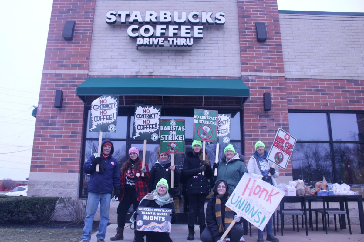 Unionized workers protest in front of the Starbucks on Carpenter Road, holding a sign telling people to honk to show support for Starbucks workers. They chanted: “What do we want? A contract? When do we want it? “Now!”  and “No Contract. No Coffee.”