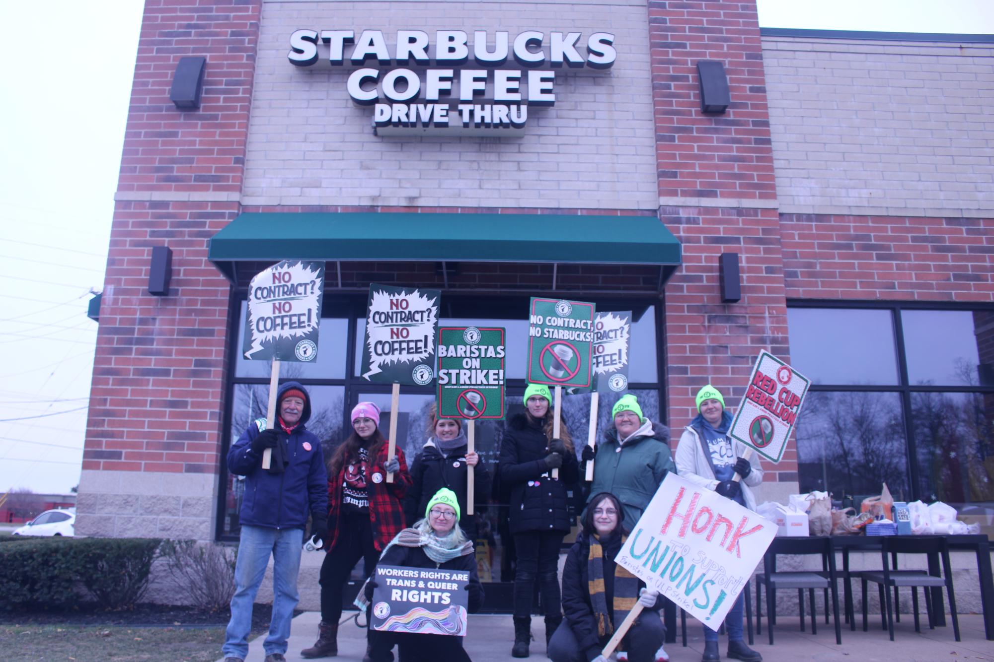 Unionized workers protest in front of the Starbucks on Carpenter Road, holding a sign telling people to honk to show support for Starbucks workers. They chanted: “What do we want? A contract? When do we want it? “Now!”  and “No Contract. No Coffee.”