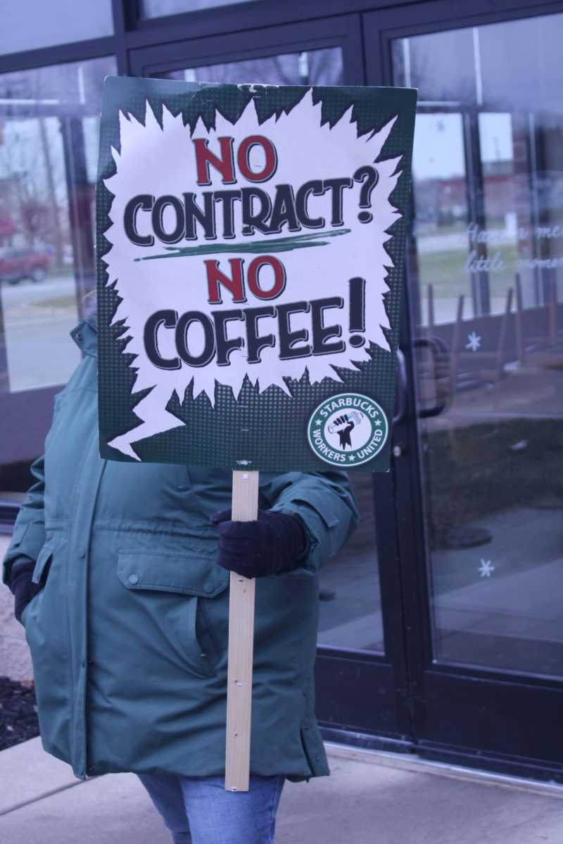 Starbucks employees picketing in front of the store on Carpenter road in Ypsilanti with a sign reading “No contract? No coffee!