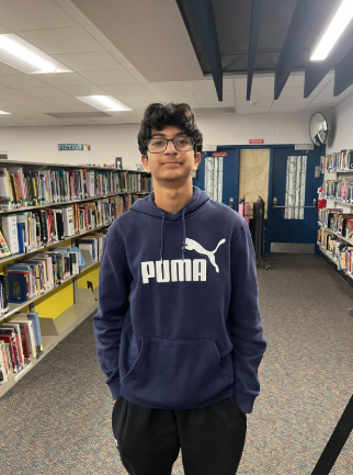 Ishaan Wasnik posting for the photo in the Clague library.