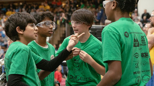 Vihaan Sharma (Driver Coach),
Vimal Srinivasan (Driver),
Matthew Bezas (Human Player),
And Charles Hyman (Driver) 
discussing their plan for the 
upcoming match. Photo courtesy of Kim Bezas
