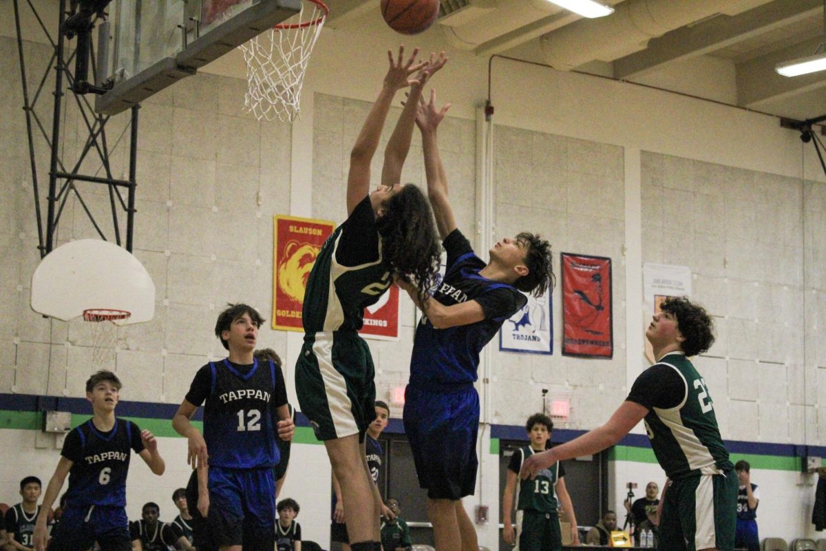 Eighth grader Adonis Frye getting a rebound over a Tappan player. 
