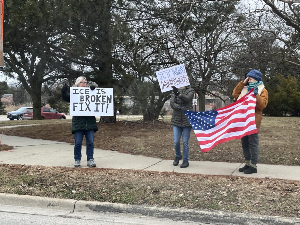 ICE protesters held signs on the corner of Plymouth and Green roads on Saturday.