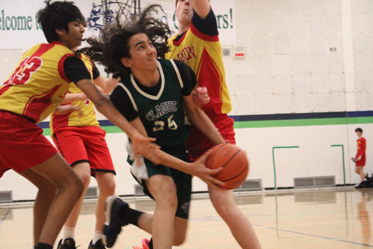 Eighth grader Adonis Frye dribbling through a 2 man trap. The final score of the game was a two point win for Scarlett 45-43.