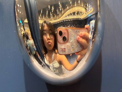 Olivia Yim taking a picture on a cruise. 
